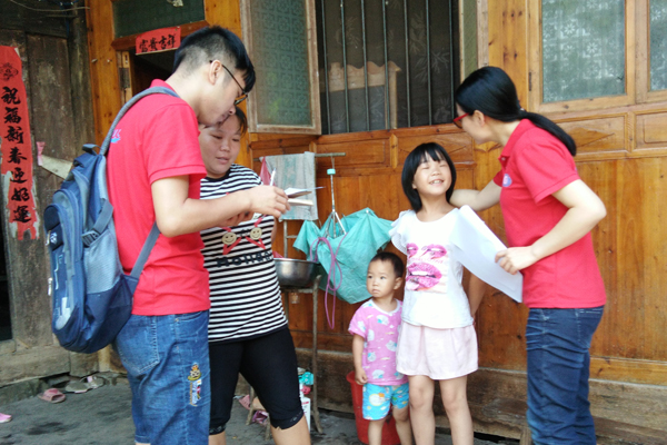 学生在做问卷调查时带队老师同小朋友亲切交谈 金远亮摄.jpg